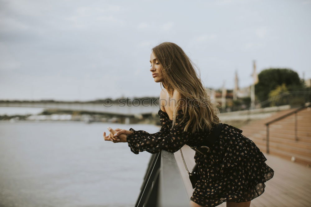 Similar – Thoughtful woman at lamp post