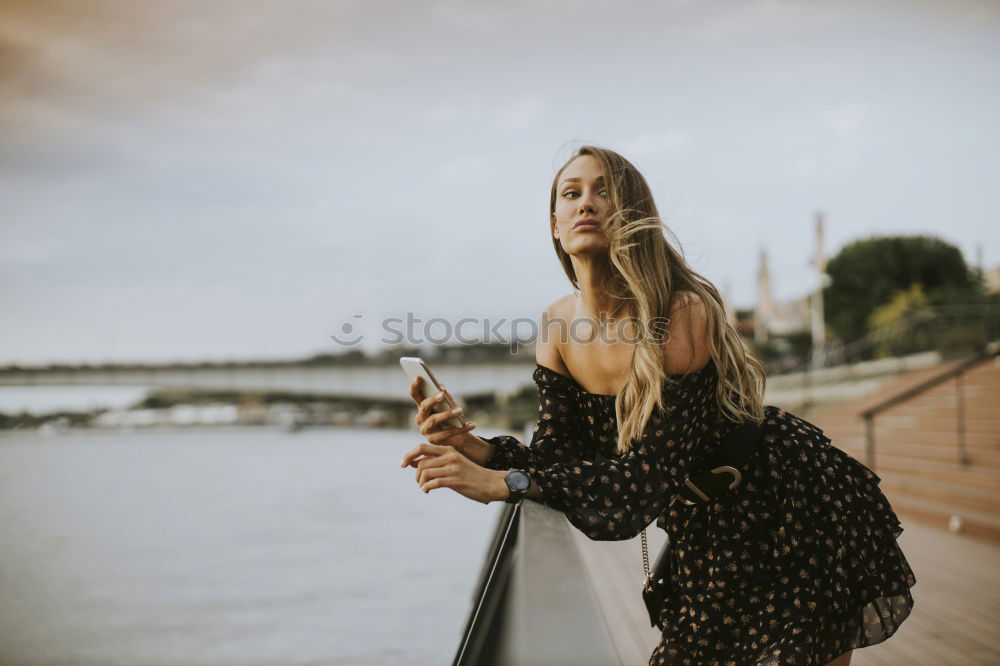 Similar – Image, Stock Photo Young woman is looking at polaroid picture at the beach