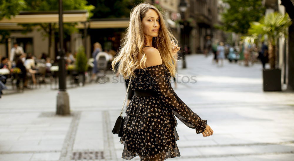 Smiling young woman in urban background.