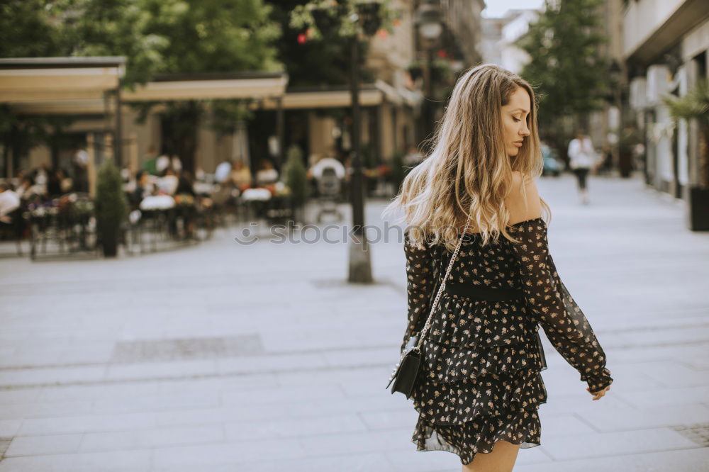 Similar – Thoughtful woman at lamp post