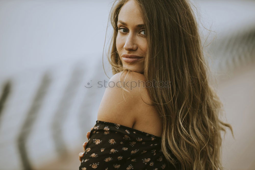 Similar – Brunette woman leaning on handrail at river