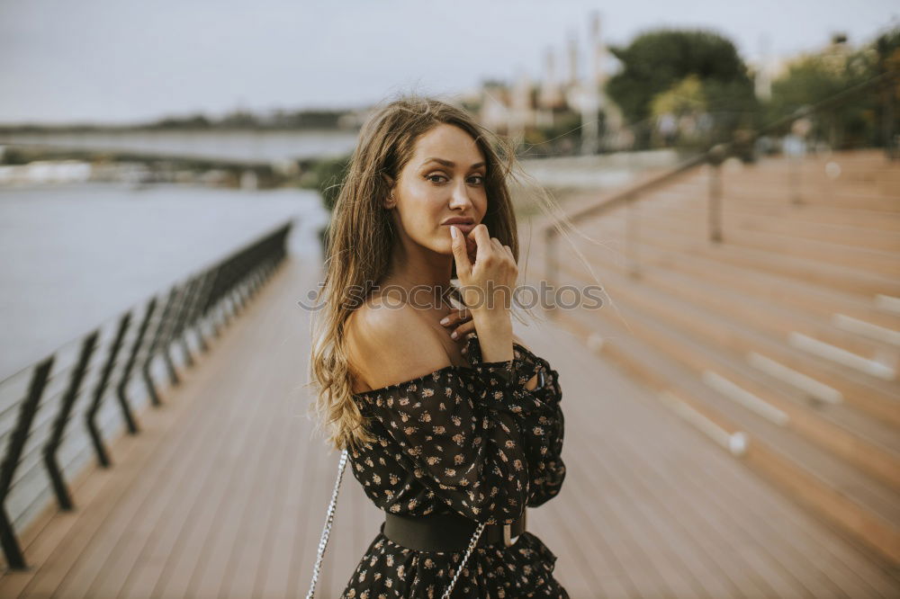 Similar – Blonde woman posing in nature, with the forest in the background