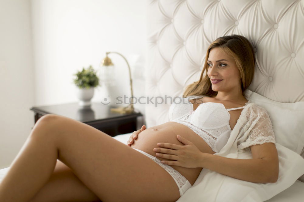 Similar – Image, Stock Photo Female expecting baby sitting on bed