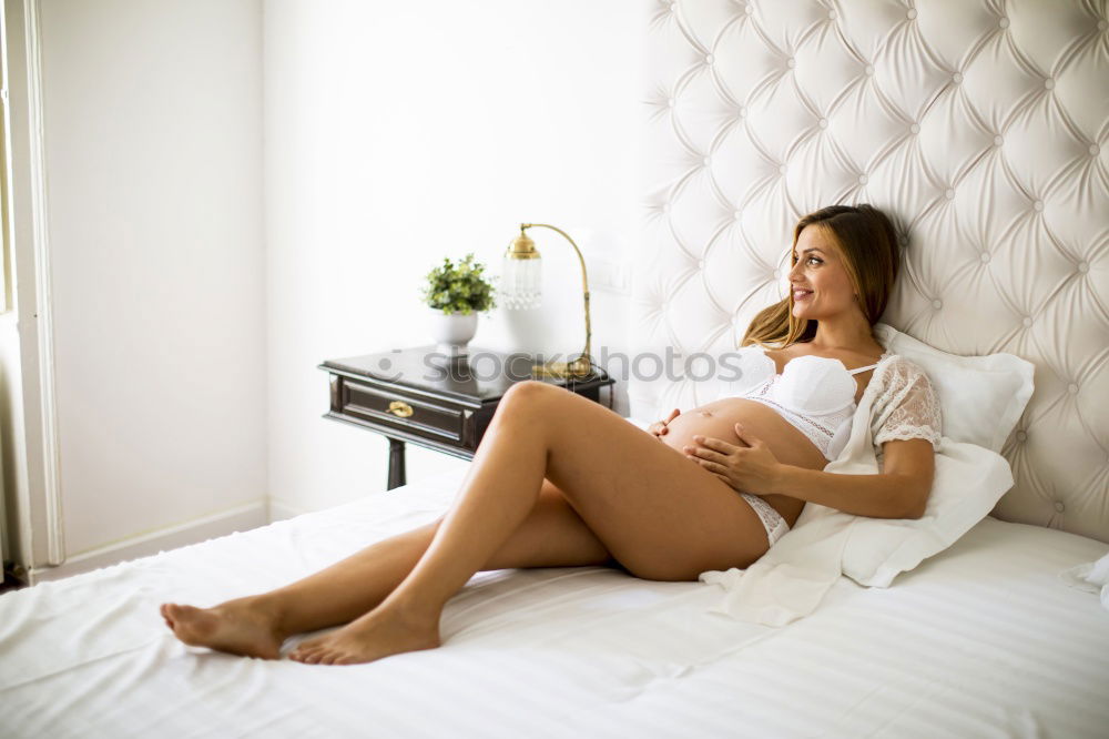 Similar – Image, Stock Photo Female expecting baby sitting on bed