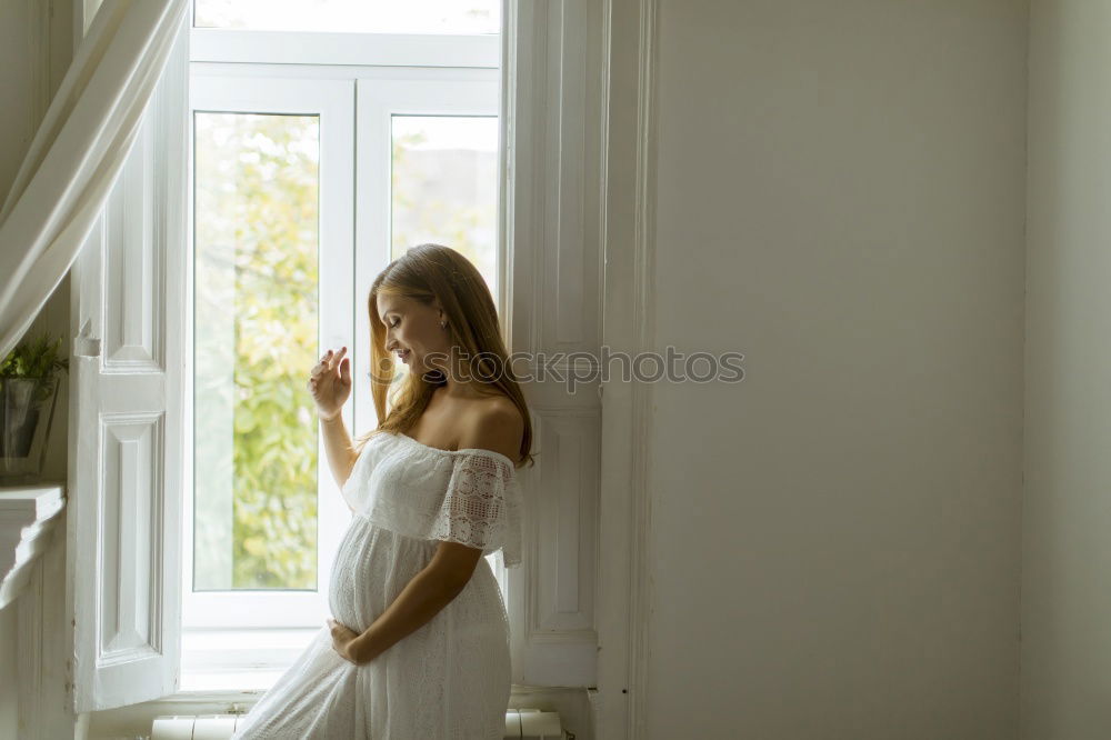 Similar – Young woman sitting in sunny kitchen in window frame enjoying coffee or tea from big cupSunday coffee