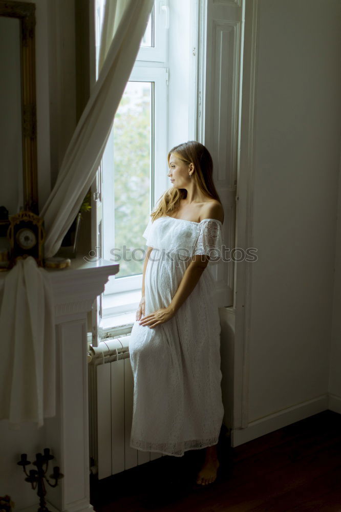 Similar – Young woman sitting in sunny kitchen in window frame enjoying coffee or tea from big cupSunday coffee