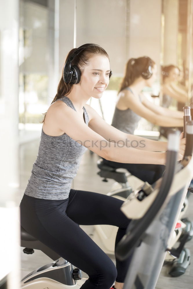 Similar – Concentrated woman in hard bike training session