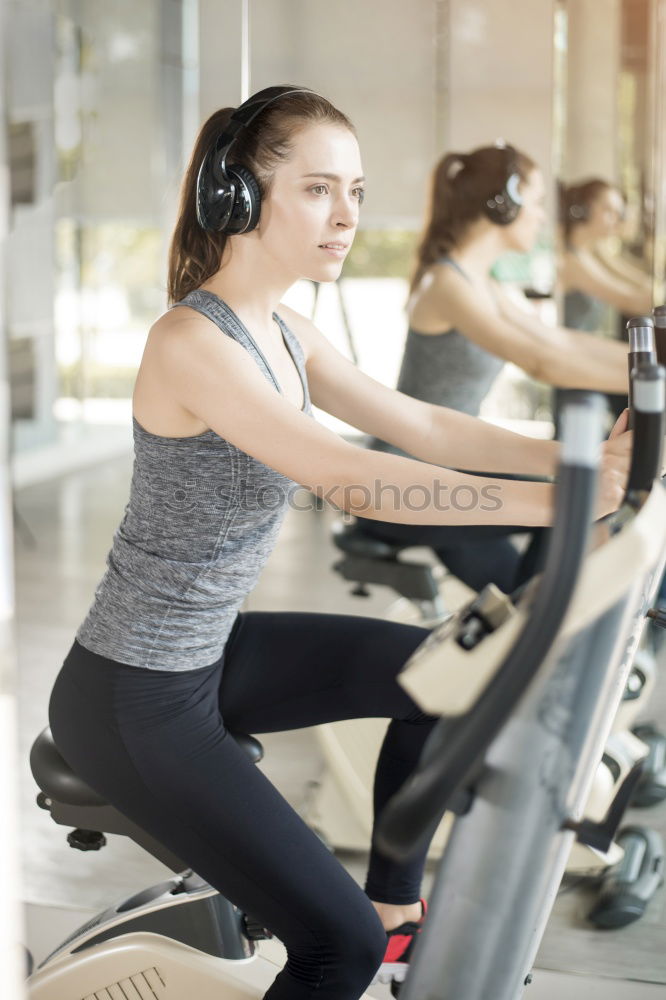 Similar – Concentrated woman in hard bike training session