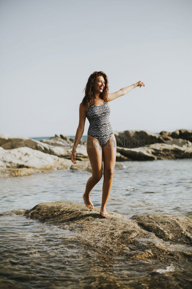 Similar – Happy girl posing on the stones of a river