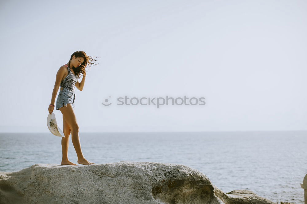 Similar – Asian woman standing on the terrace and looking around the sea.