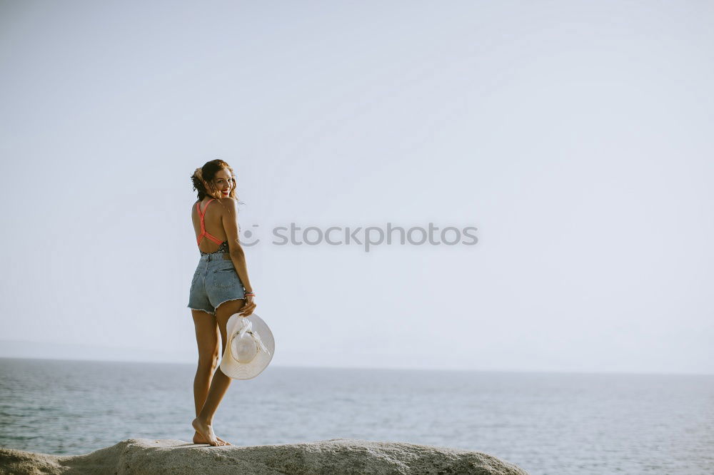 Similar – Asian woman standing on the terrace and looking around the sea.