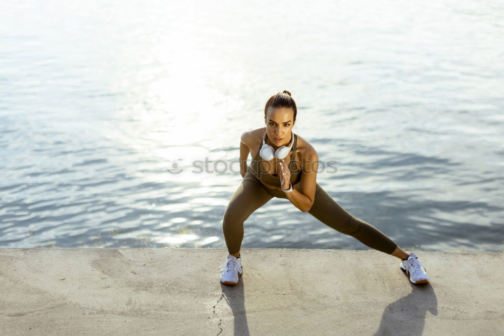 Similar – Young black woman doing stretching after running outdoors