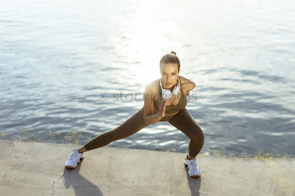 Similar – Young black woman doing stretching after running outdoors