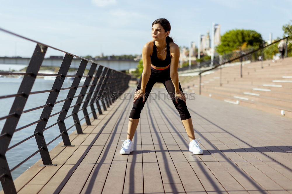 Similar – Young black woman doing stretching after running outdoors