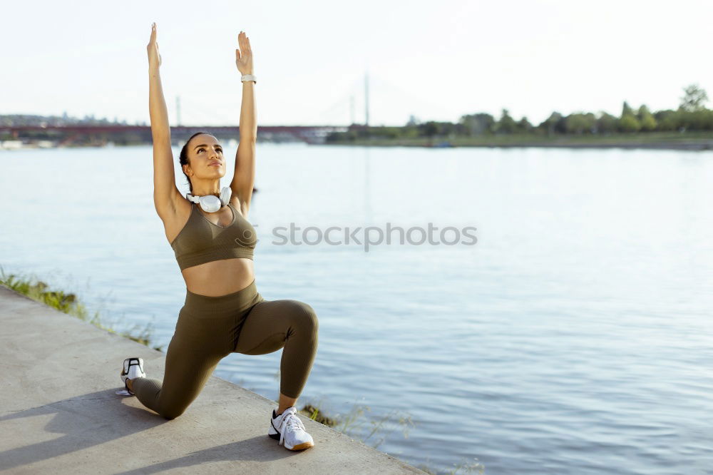 Similar – African American sportive woman sitting in lotus pose and stretching hands up