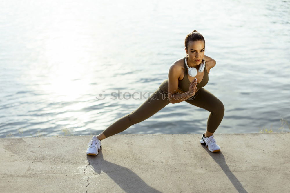 Similar – Young black woman doing stretching after running outdoors