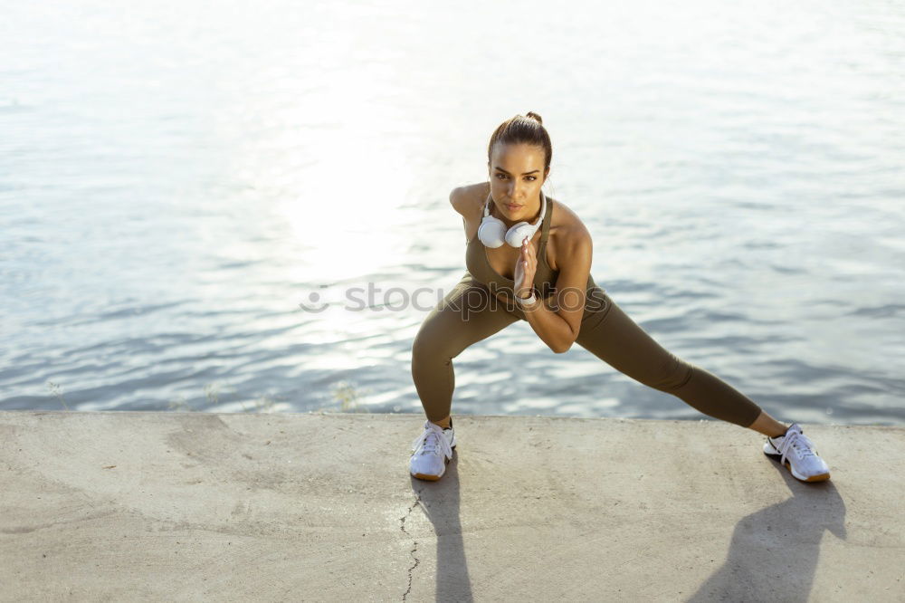 Similar – Young black woman doing stretching after running outdoors