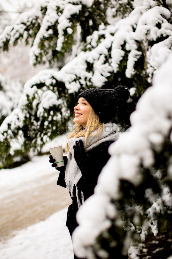 Similar – portrait Young pretty woman enjoying and playing with snow in winter