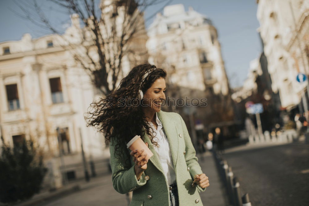 Young black woman drinking coffee wandering in the streets of Madrid on winter