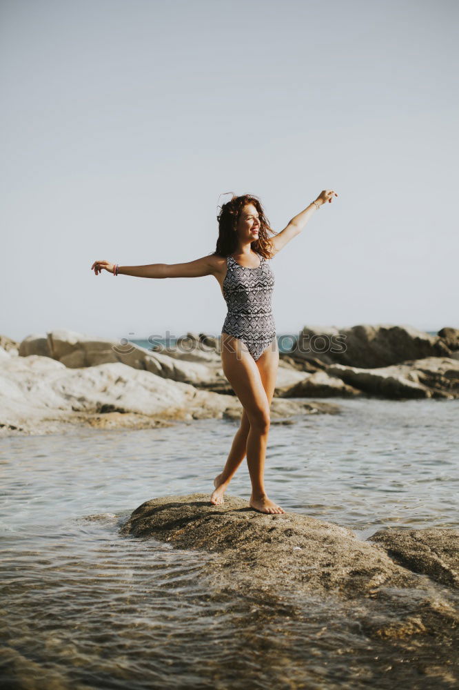 Similar – Image, Stock Photo Beautiful young woman wearing a bikini in a wooden foot bridge at the beach