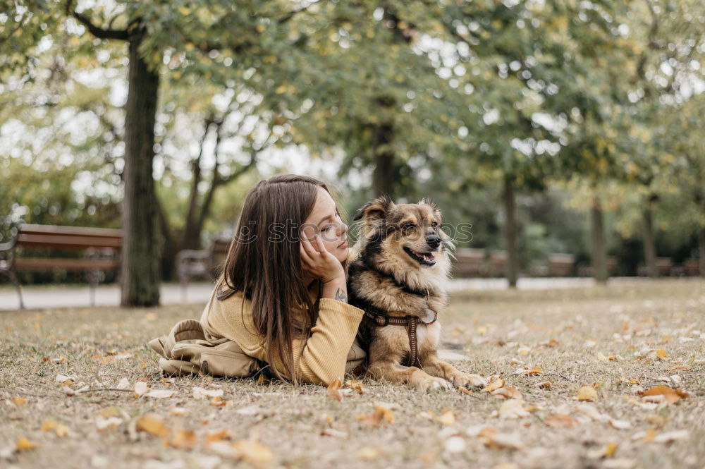 Similar – young woman with her dog at the park. she is kissing the dog. autumn season