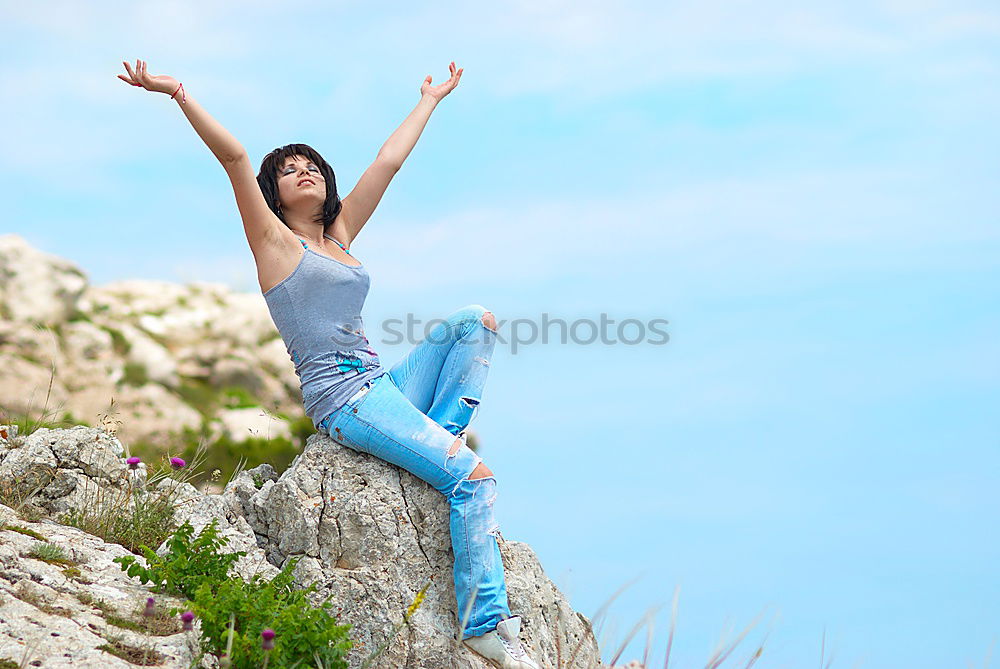 Similar – Foto Bild eine junge Frau steht auf einem grossen Stein, dahinter strahlt der blaue Himmel. Sie trägt eine rote Bluse und schwarze Hosen.