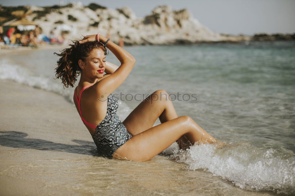 Similar – Beautiful young woman posing on the sand in a desert dunes