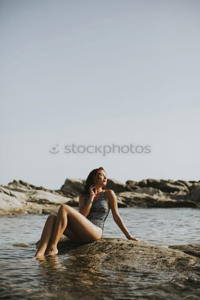 Similar – Image, Stock Photo Woman standing in the sea splashing with water in the evening light