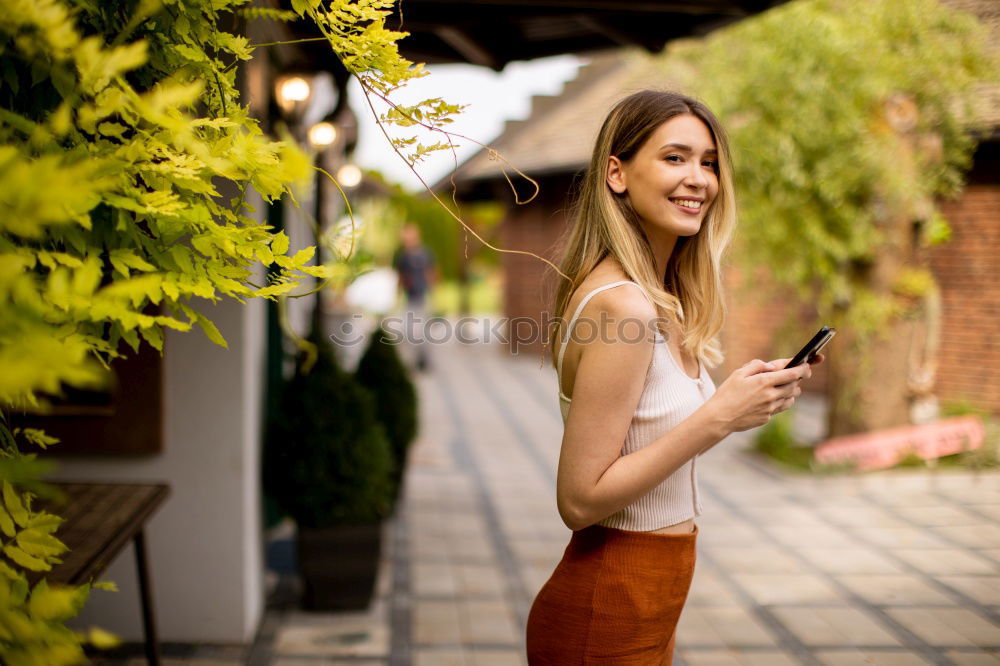 Similar – Image, Stock Photo Girl sitting in a street bar looking at her smartphone