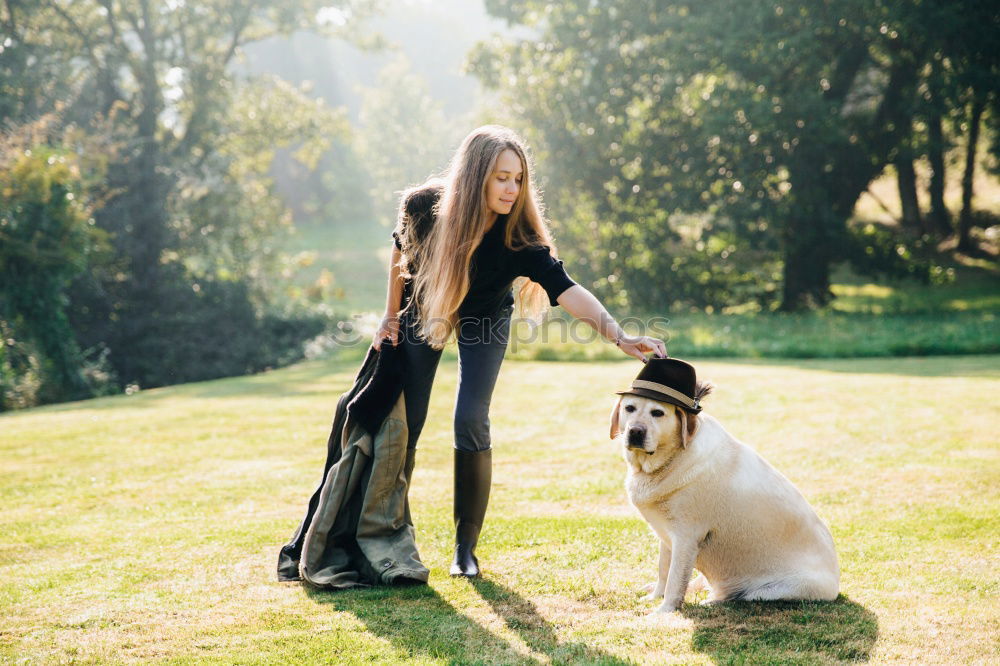 Similar – Image, Stock Photo Portrait of young blond Labrador with young tall beautiful woman with long dark curls in back light forest