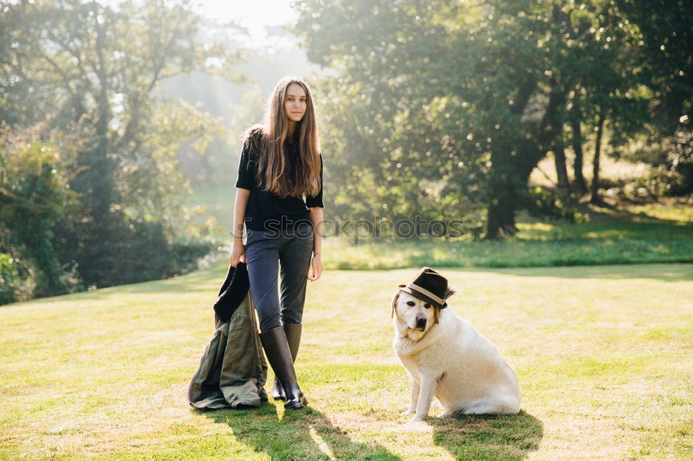 Similar – Image, Stock Photo Portrait of young blond Labrador with young tall beautiful woman with long dark curls in back light forest