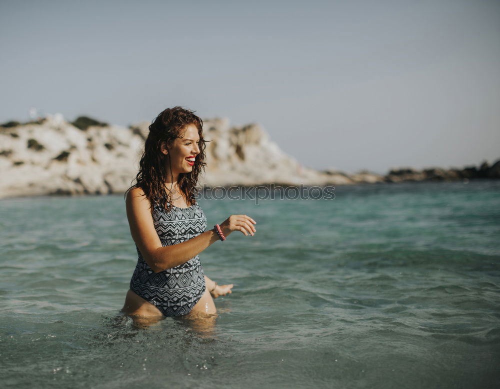 Similar – Image, Stock Photo Young girl standing on the rocks, watching sunset