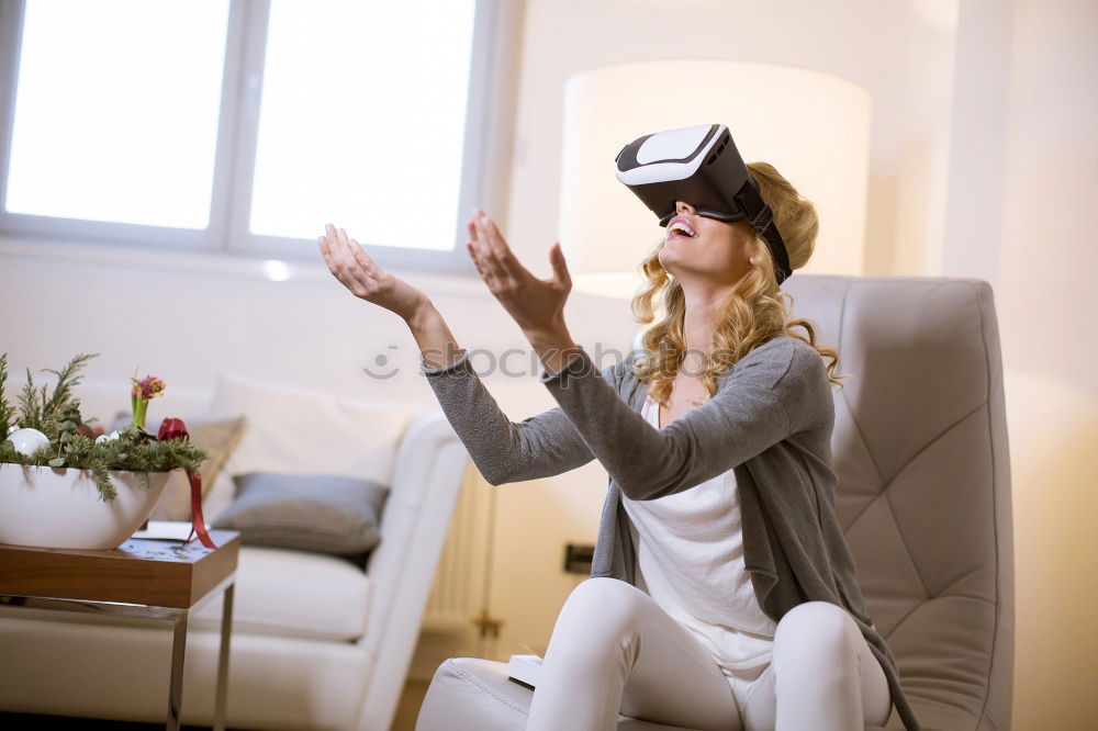 Similar – Image, Stock Photo Woman experiencing virtual reality in home