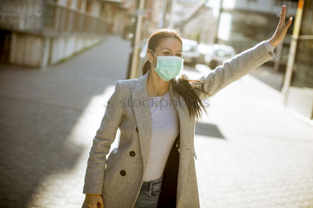 Similar – Female teenager in protective mask standing near electric scooter