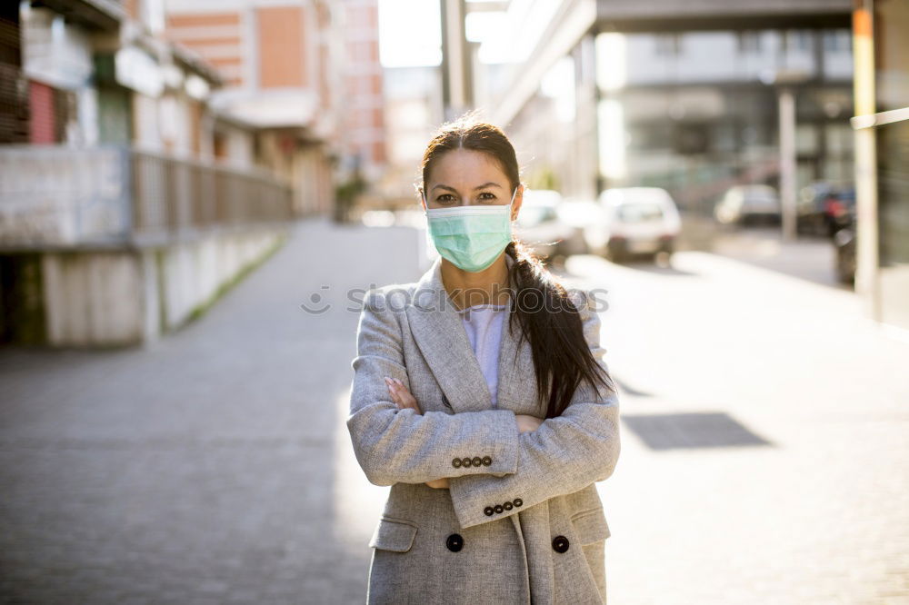 Similar – Female teenager in protective mask standing near electric scooter