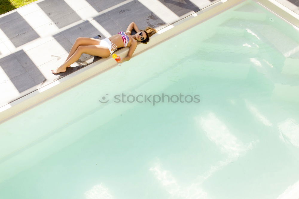 Similar – Two young women in swimsuits relaxing in the swimming pool