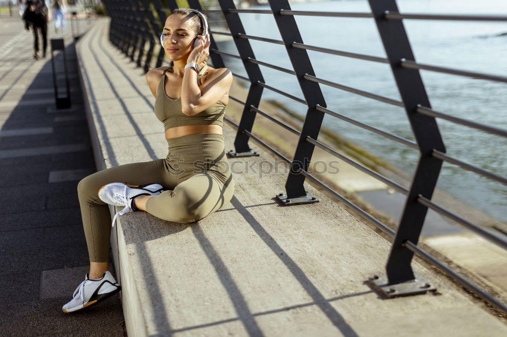 Fit smiling female adult resting after exhausting training