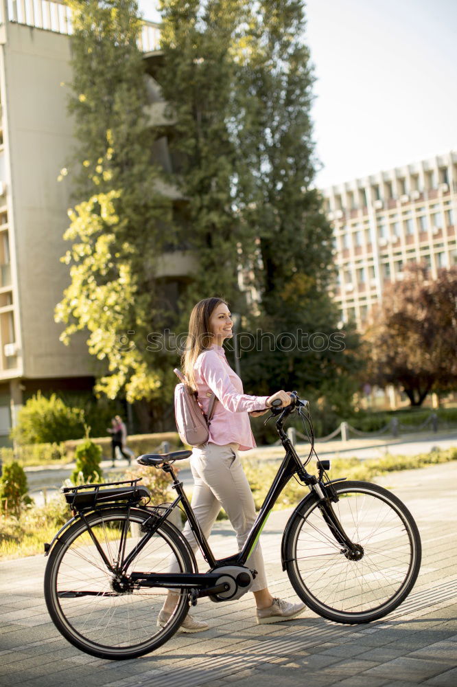 Similar – Happy family with a child riding bicycles by the city