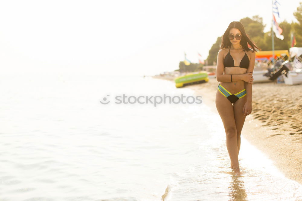 Similar – Image, Stock Photo Beautiful young woman wearing a bikini in a wooden foot bridge at the beach