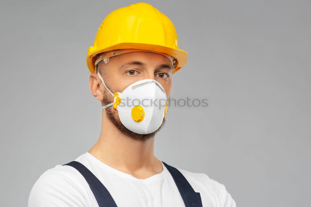 Similar – Workman in protective mask and glasses standing on street