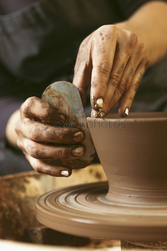 Similar – Potter makes clay bottle