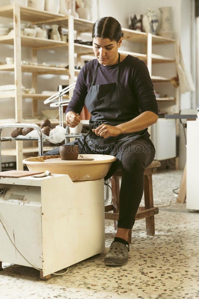 Carpenter cutting wooden board at his workshop