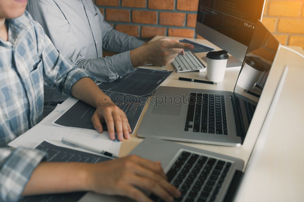 Similar – Two businessman meeting and using smartphone with laptop at outdoor cafe