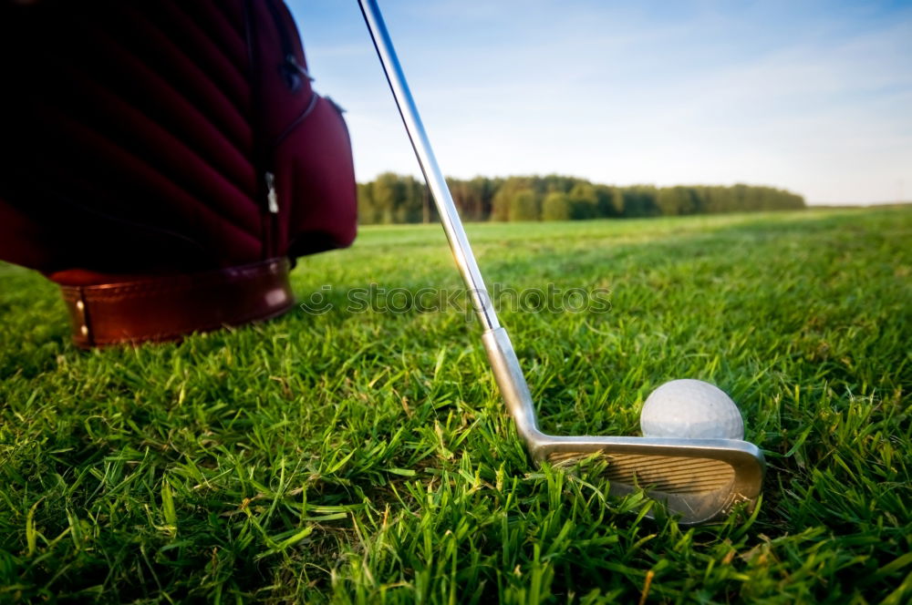 Similar – Golfer performs a golf shot from the fairway