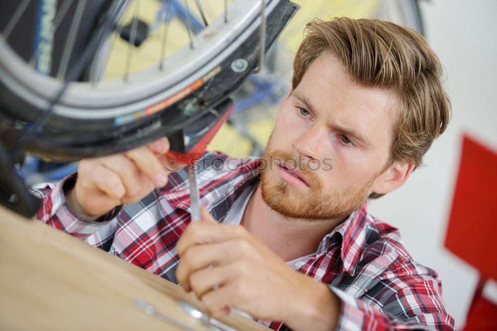 Similar – Man working on bike