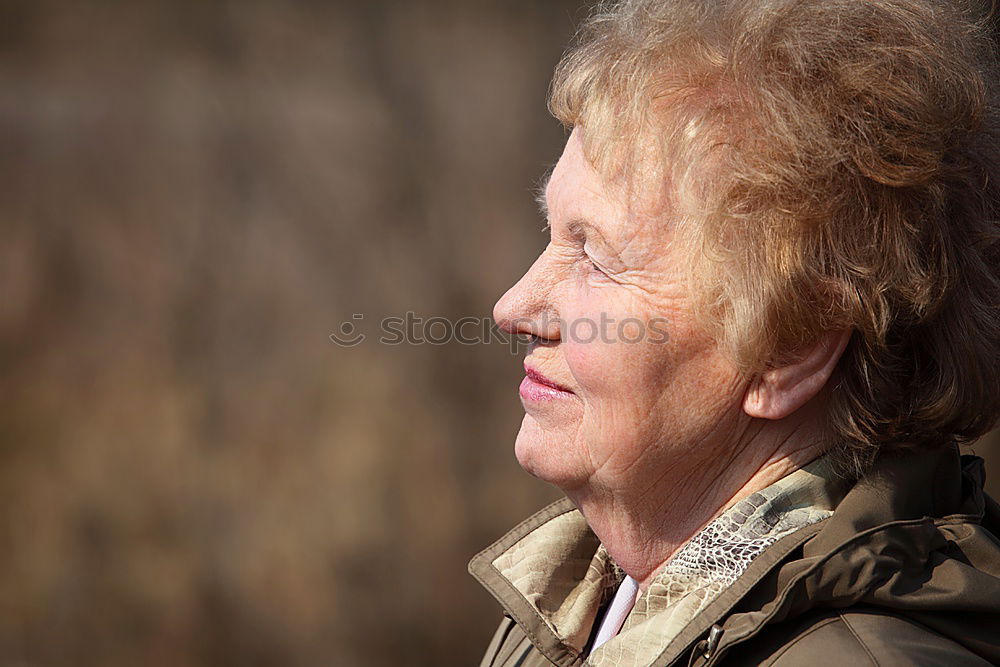 Similar – Senior citizen looks up in autumn forest