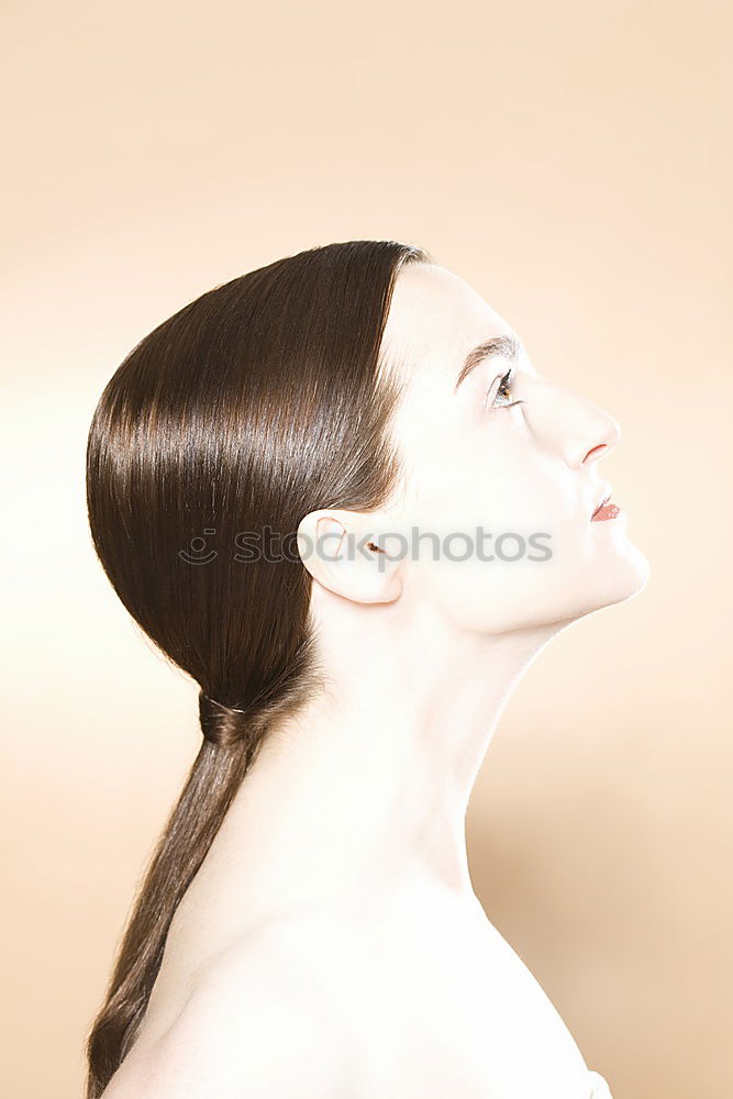 Analogue (6×6) back portrait of young woman with long brunette hair tied into a braid