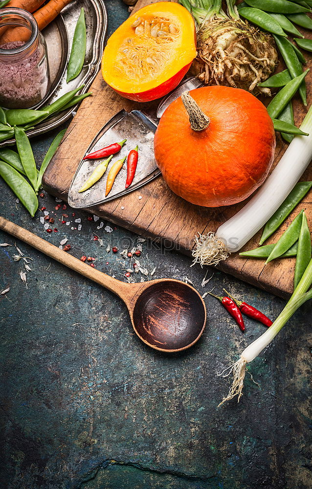 Pumpkin, cooking spoon and vegetables