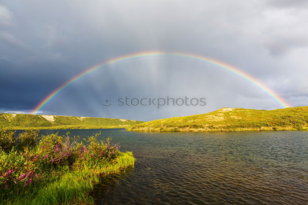 Similar – Image, Stock Photo A man stands at the beginning of a whole rainbow that spans a valley