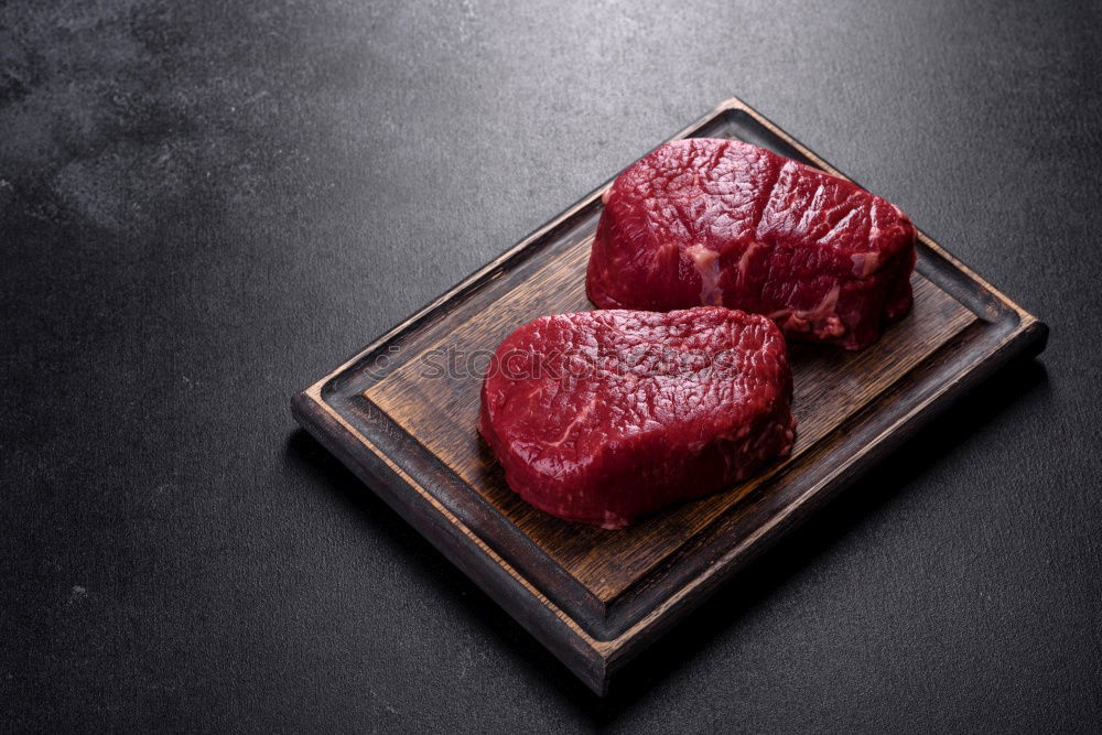 Similar – Image, Stock Photo Steaks with ingredients on a round chopping board